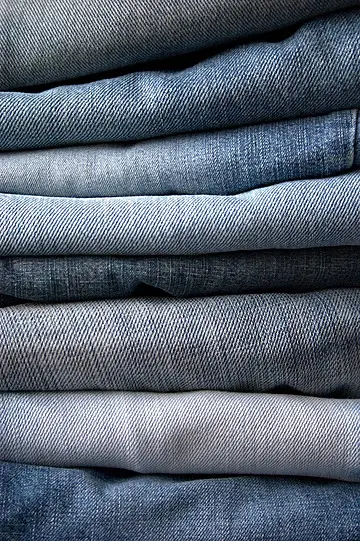 pngtree-vintage-stonewashed-blue-denim-jeans-stacked-goods-fabric-selection-photo-photo-image_65438690